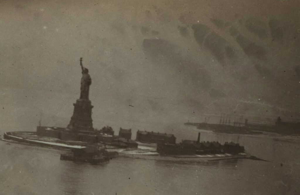 The Statue of Liberty in 1912, with Black Tom Island in the background, to the right